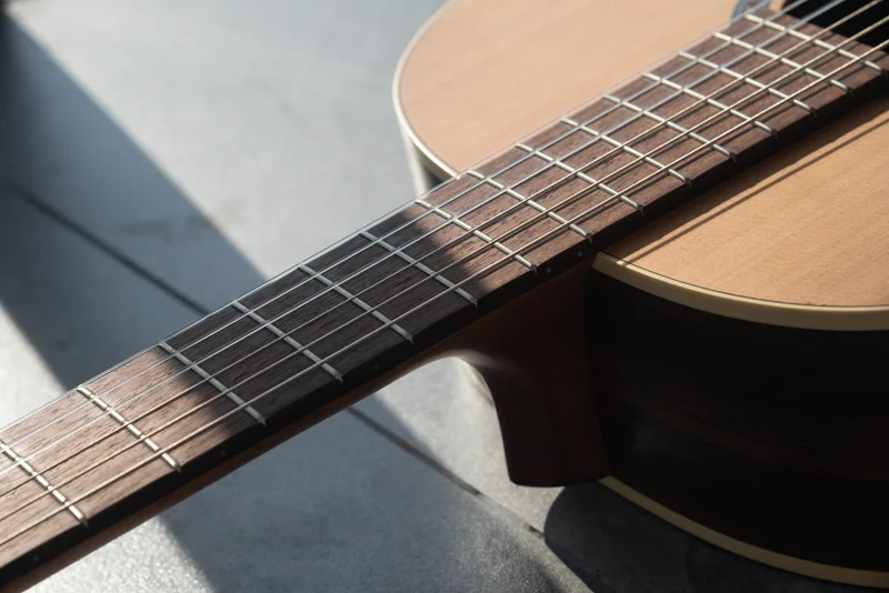 Close-up of a Godin Presentation classical guitar body in natural light.